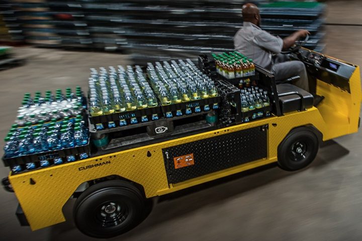 Cushman Titan XD loaded with beverage bottles at a distribution center