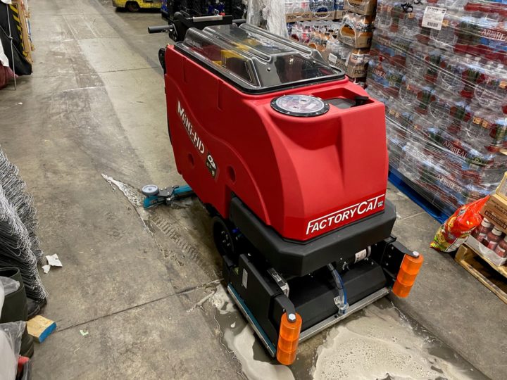 Factory Cat Mini-HD Floor Scrubber cleaning a grocery store warehouse