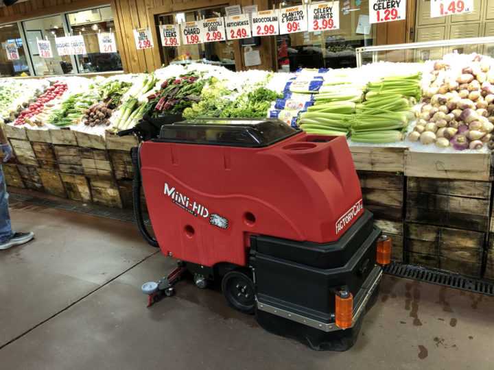 Factory Cat Mini-HD Floor Scrubber cleaning a grocery store produce aisle