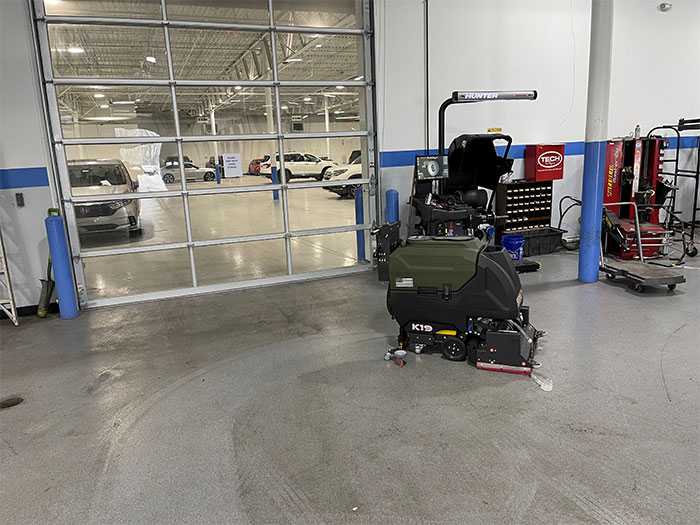 Kodiak K19 Walk-Behind Floor Scrubber in an auto garage