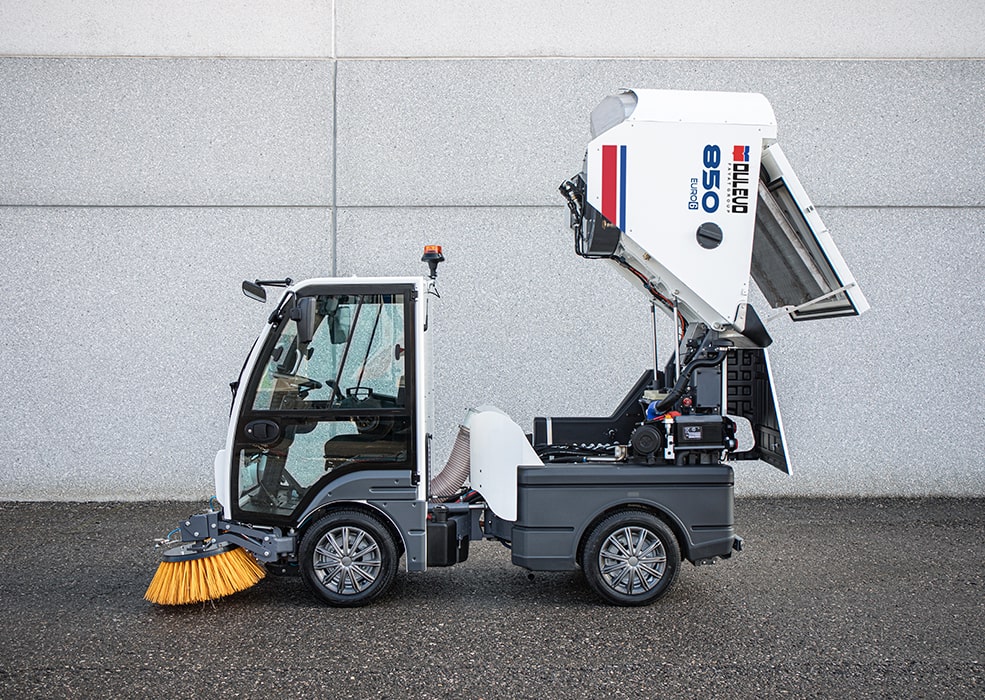 A Dulevo 850 Sweeper with its hopper tilted back vertically for dumping.