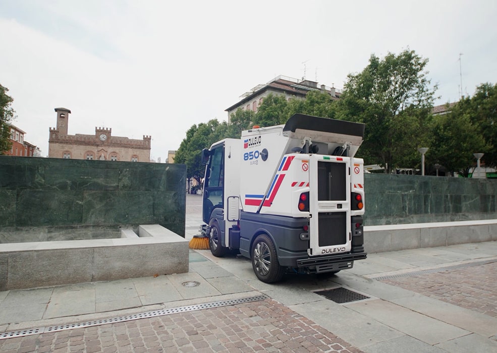 A Dulevo 850 Sweeper on a public paved stone pedestrian path.