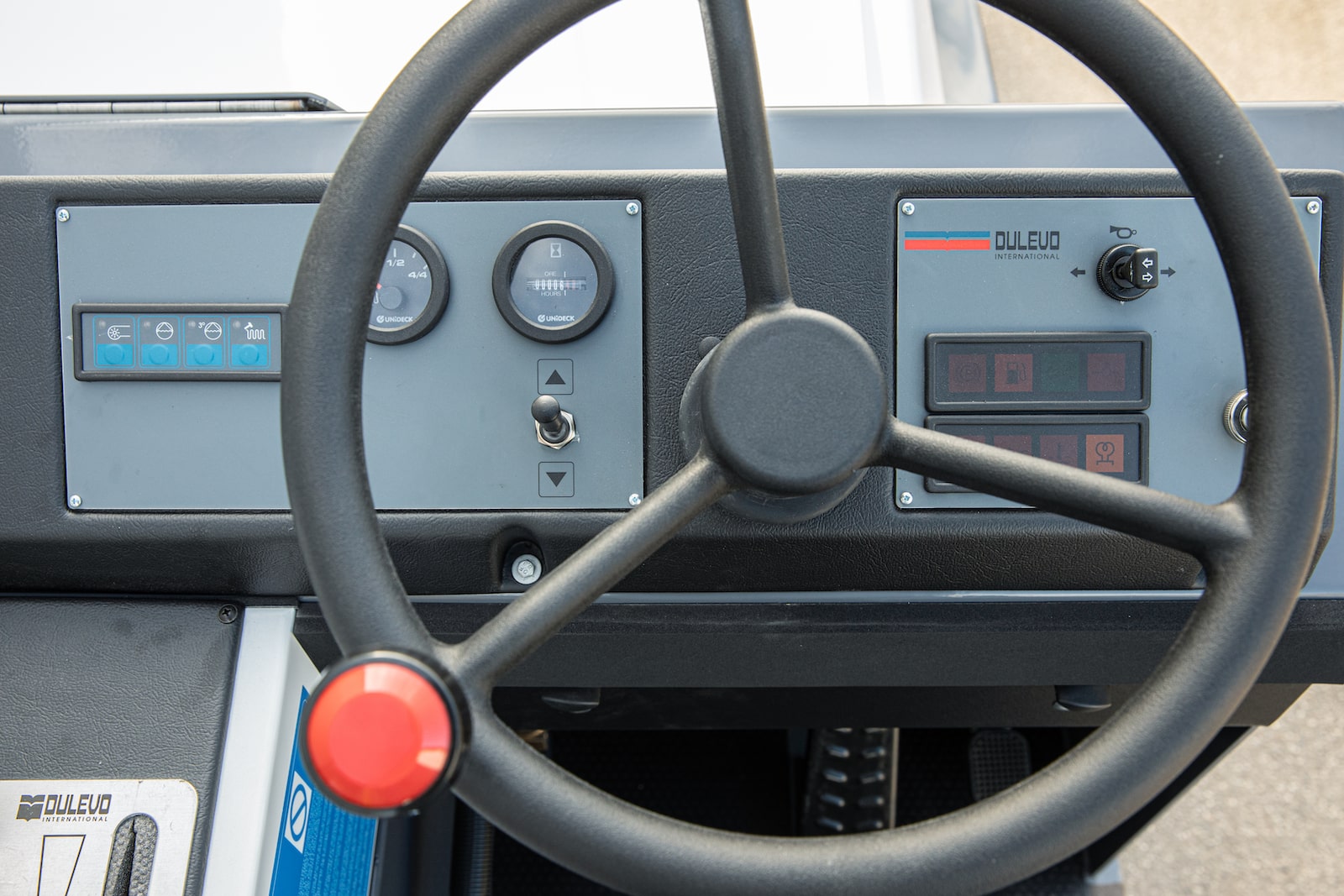The steering wheel and dashboard of a Dulevo 120 sweeper.