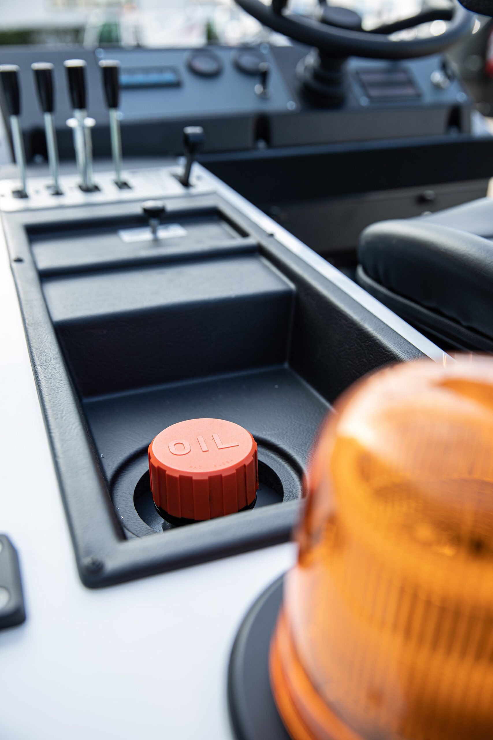 An easy-to-refill oil tank near the seat on a Dulevo 120 Sweeper.