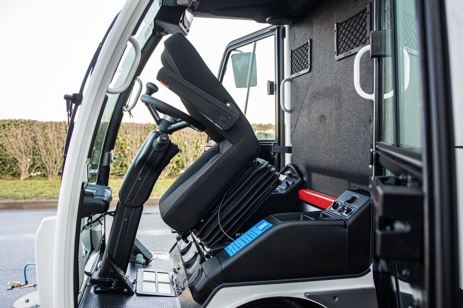 Dulevo 850 Sweeper with driver's seat tilted forward for storage access.