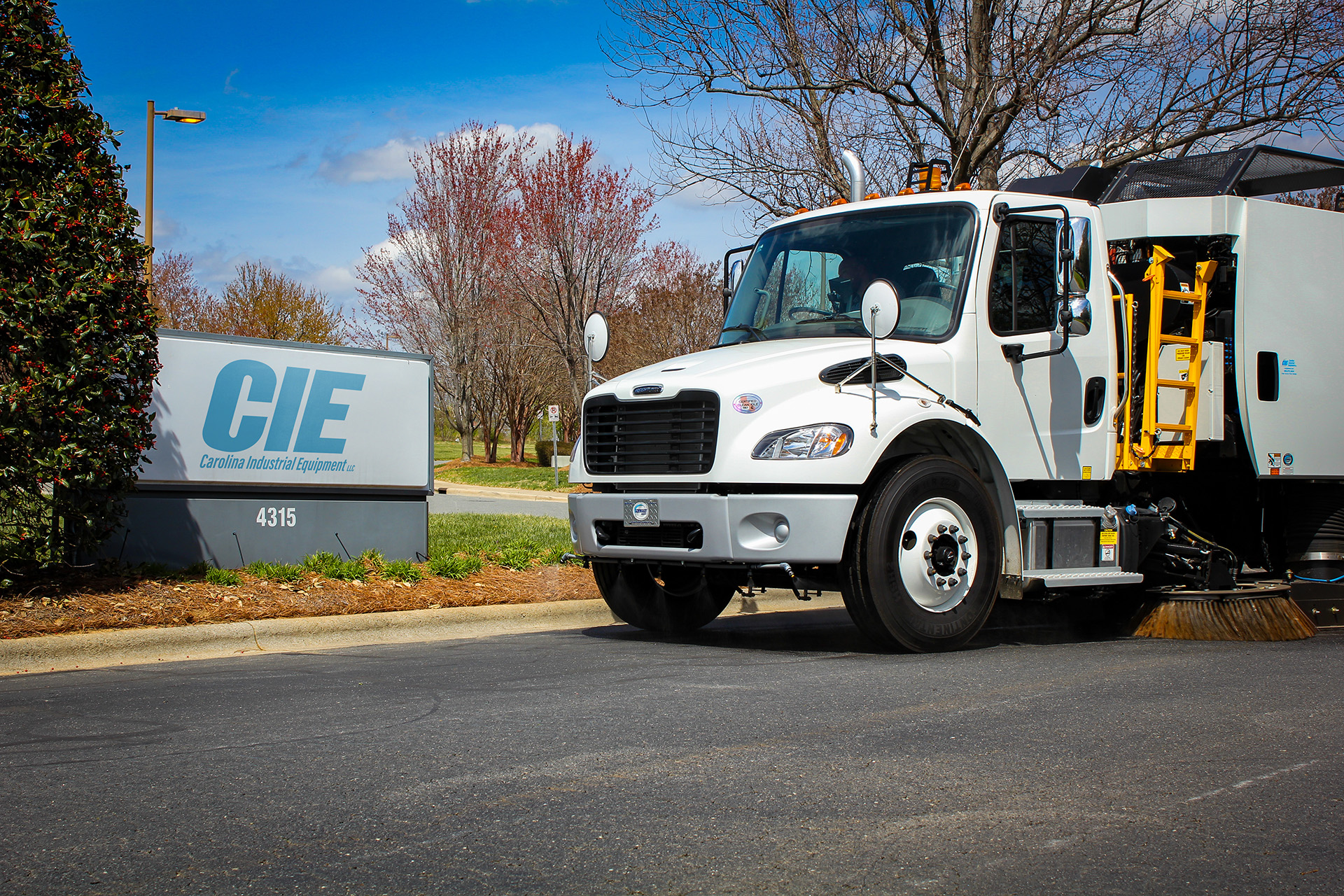 Carolina Industrial Equipment Sign in front of Schwarze Street Sweeper